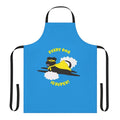 A black dog wearing a superhero costume and cape on an apron