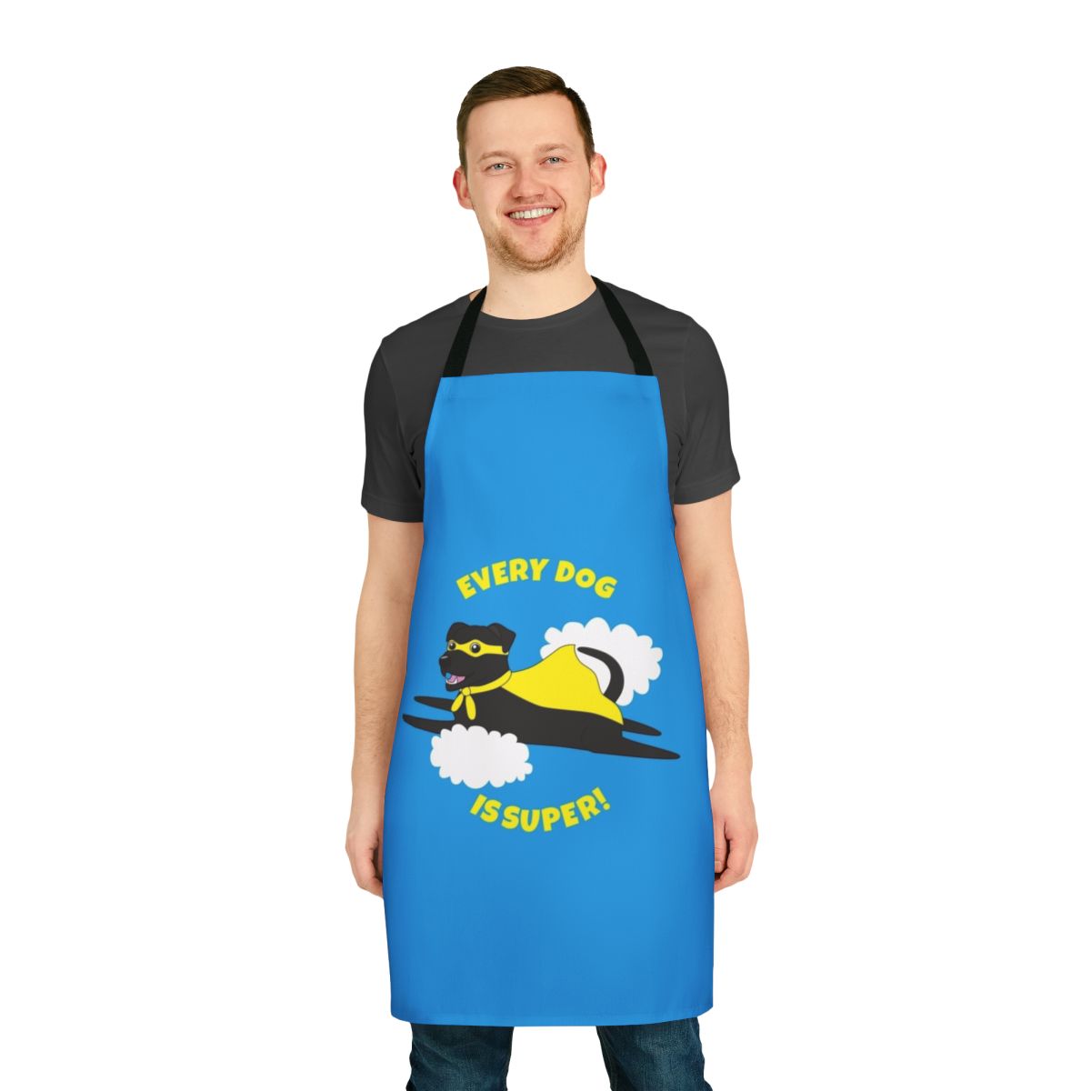A black dog wearing a superhero costume and cape on an apron