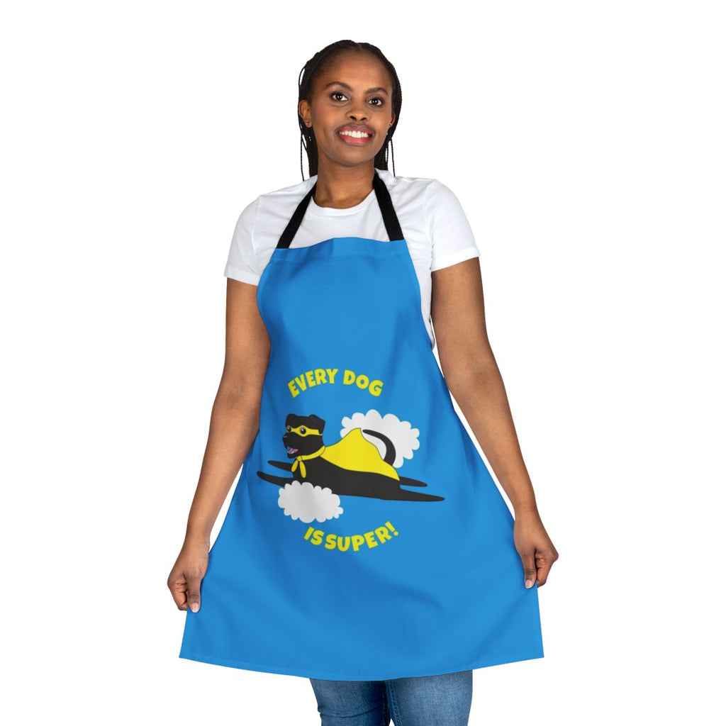 A black dog wearing a superhero costume and cape on an apron