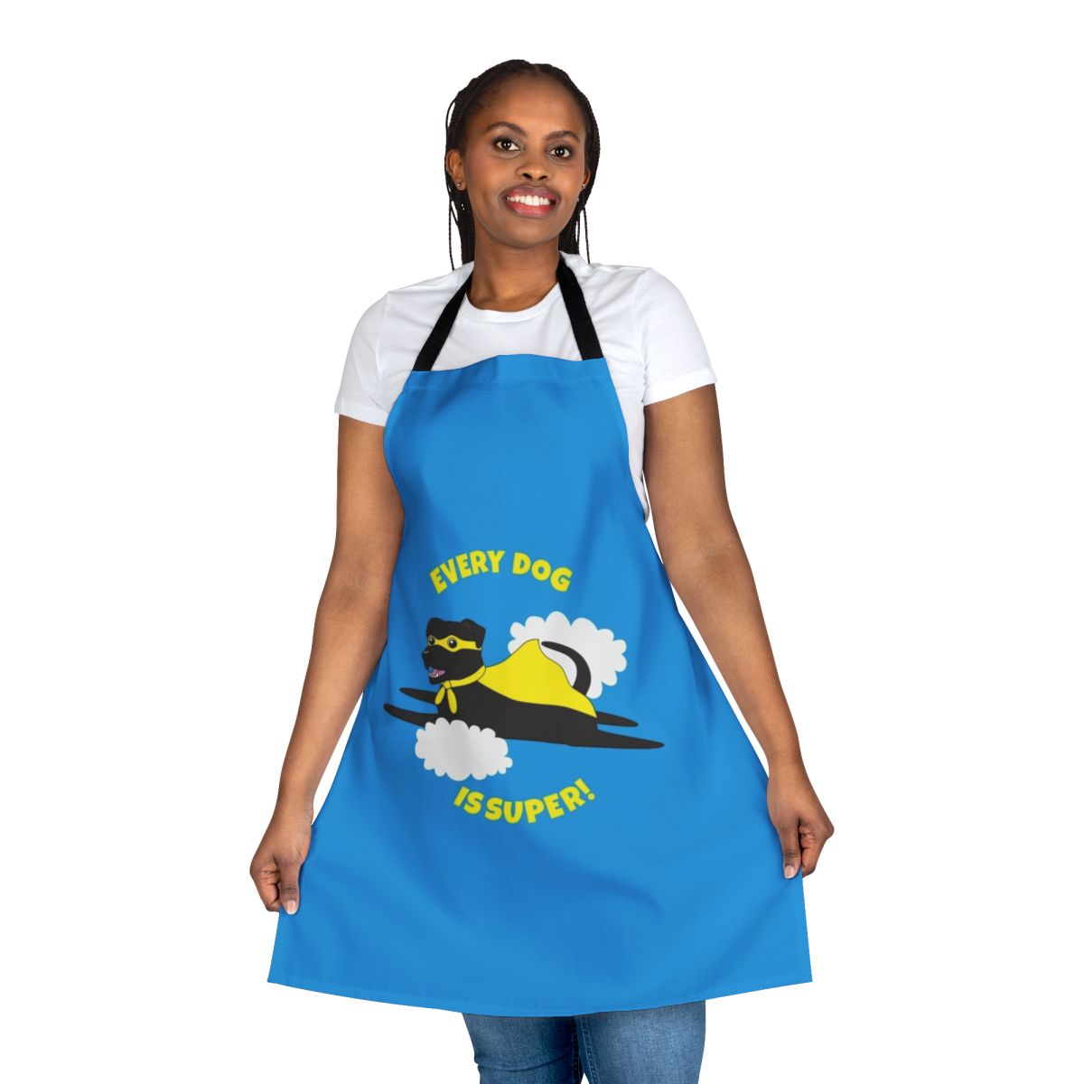 A black dog wearing a superhero costume and cape on an apron
