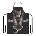 Cute gray cat sitting in a baby carrier attached to a gray apron