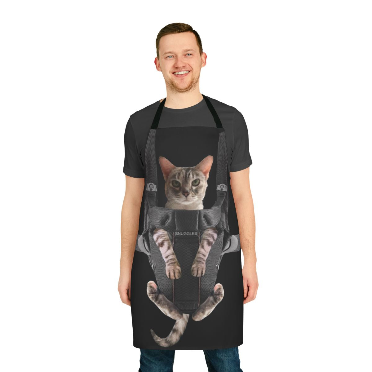 Cute gray cat sitting in a baby carrier attached to a gray apron