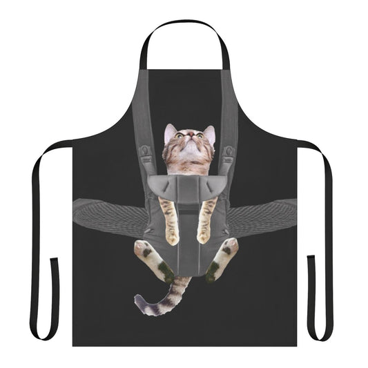 Tabby cat sitting in a baby carrier attached to an apron
