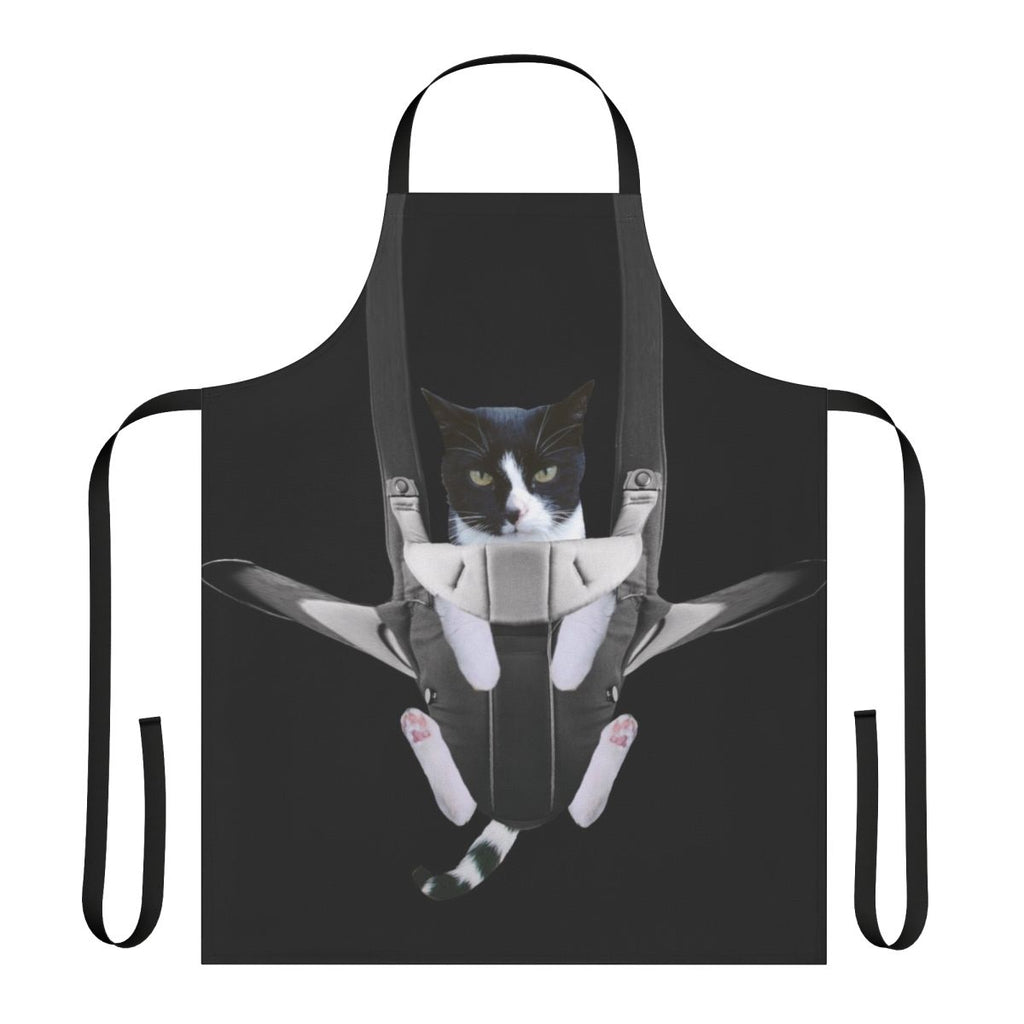 A cat snuggled inside a baby carrier-style apron
