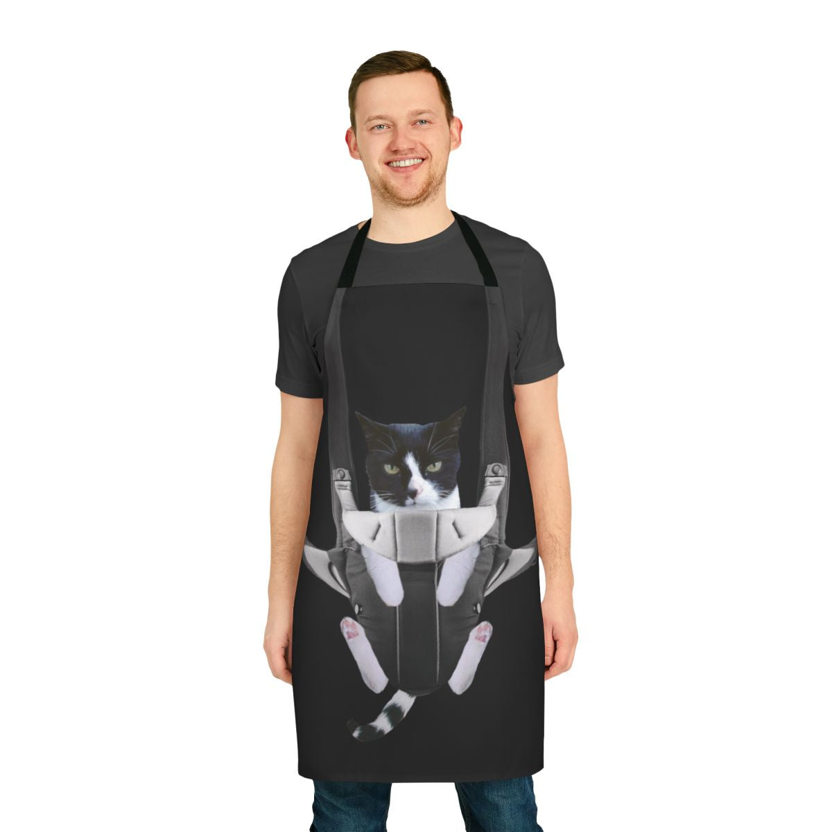 A cat snuggled inside a baby carrier-style apron
