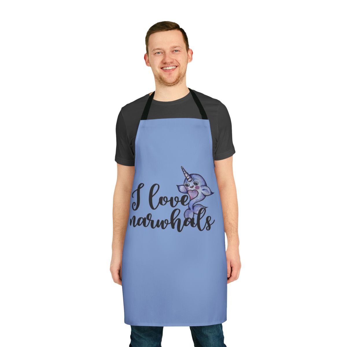 "A vibrant purple and pink apron featuring a cute narwhal design, perfect for fans of these legendary marine animals."