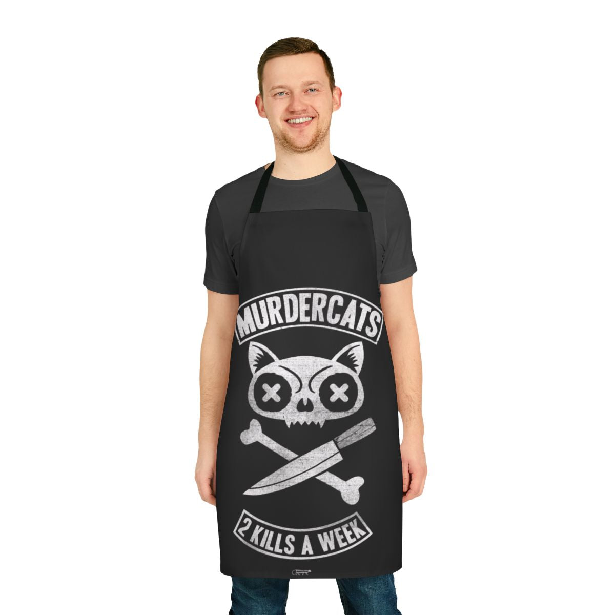 Photograph of a black and white cat-themed apron with the text "Murdercats" printed on it.