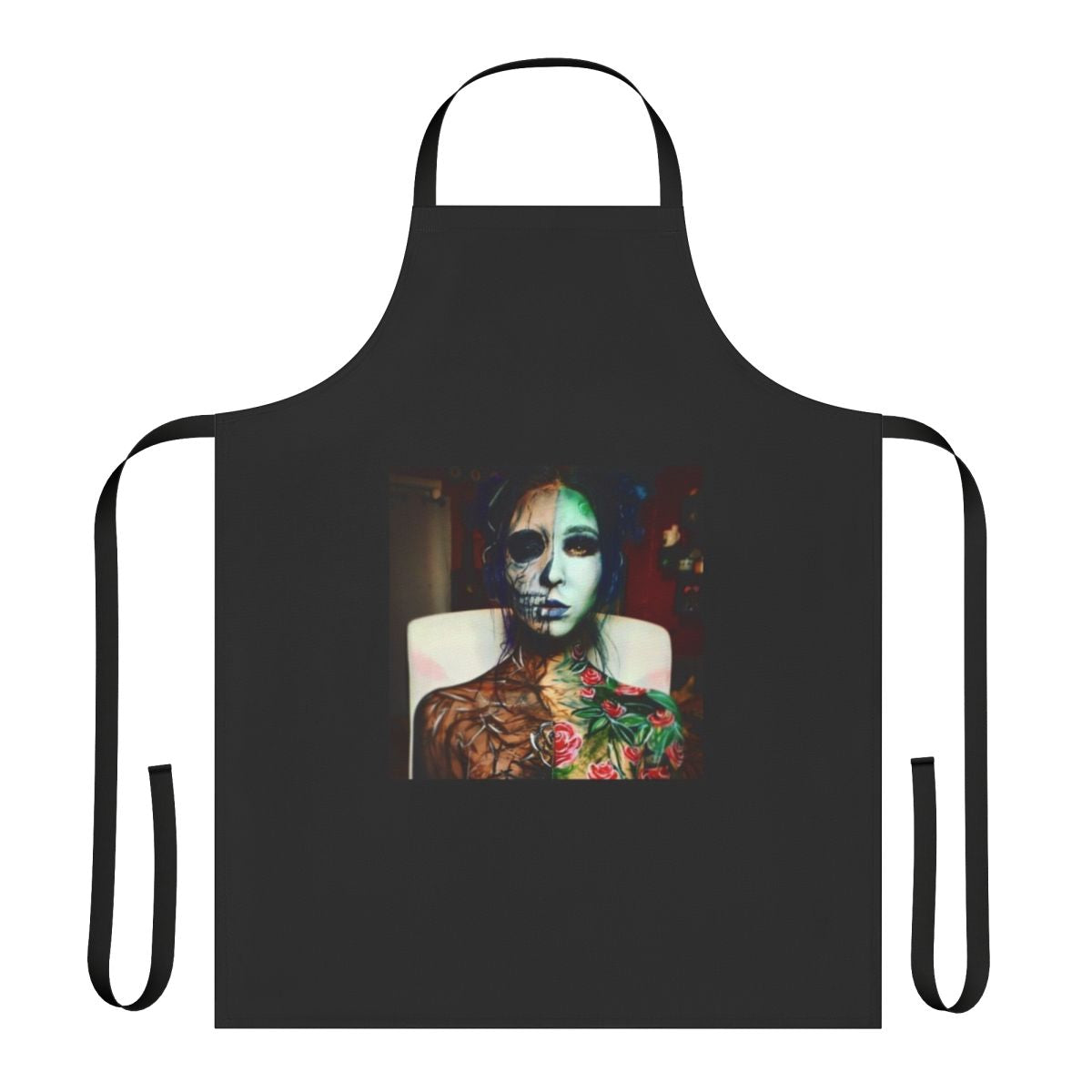 A black apron featuring a dramatic life and death bodypaint design, perfect for artistic cooks and crafters.