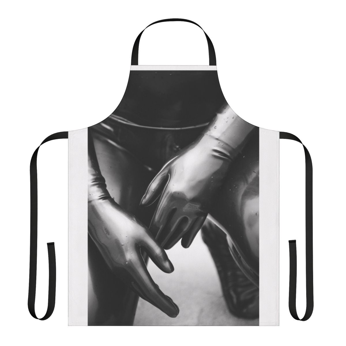 Artsy photograph of a person wearing a black and white latex gloves apron with a shallow depth of field.