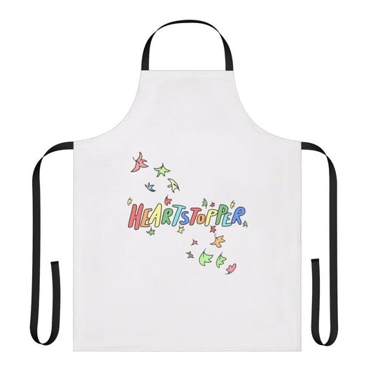 A high-quality kitchen apron featuring an autumnal, leaf-themed design inspired by the LGBTQ+ webcomic series "Heartstopper".