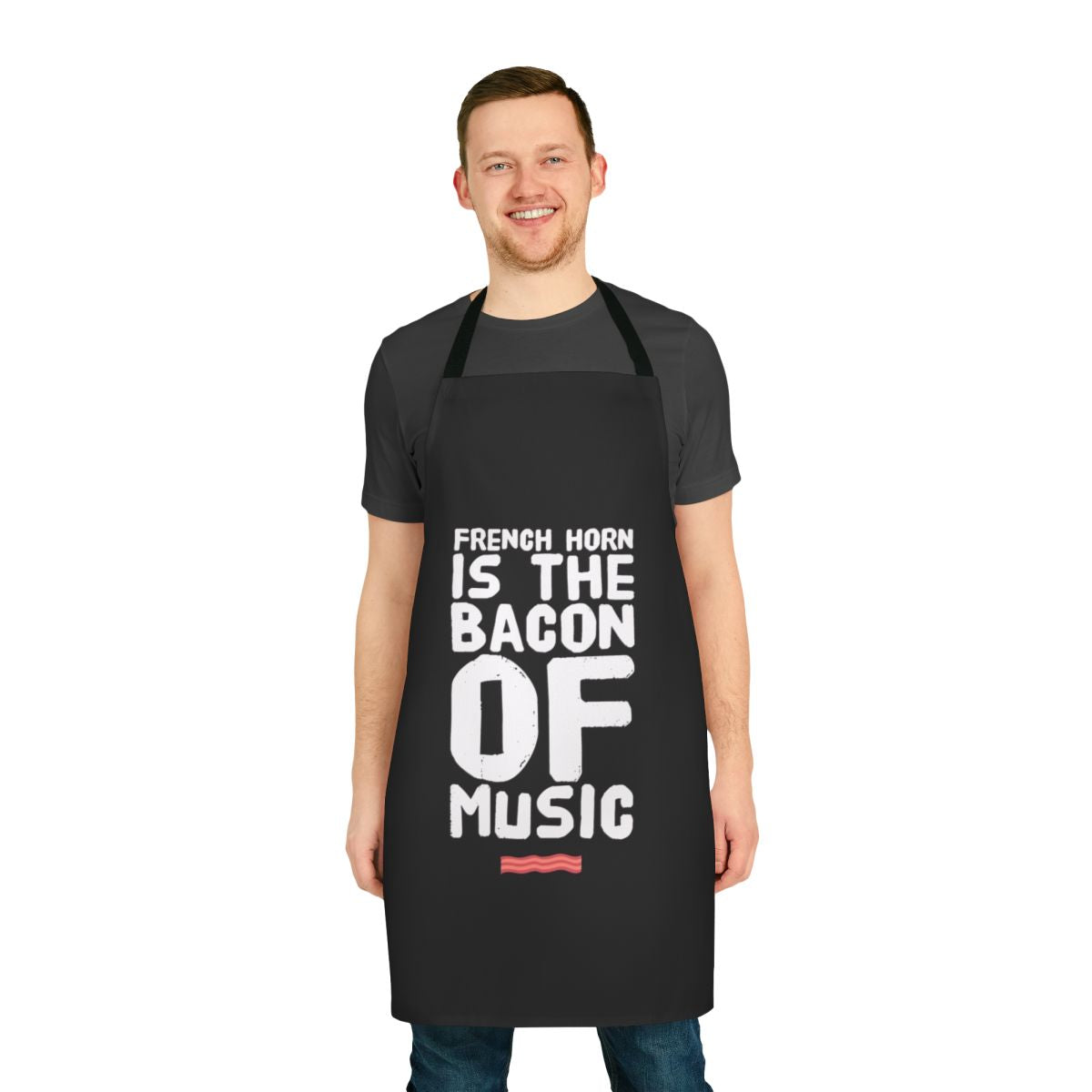 A funny apron featuring the text "French Horn is the Bacon of Music" on a black background.