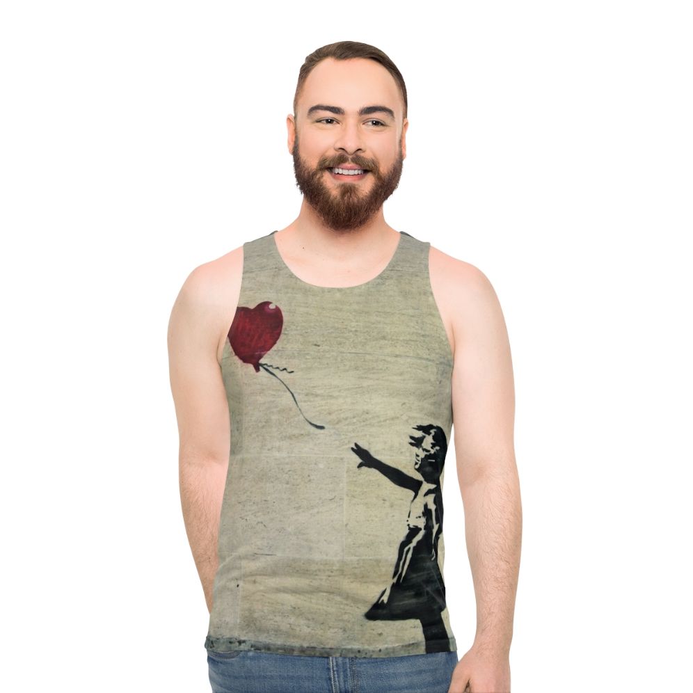 Banksy's iconic "Girl with a Red Balloon" street art design on a unisex tank top