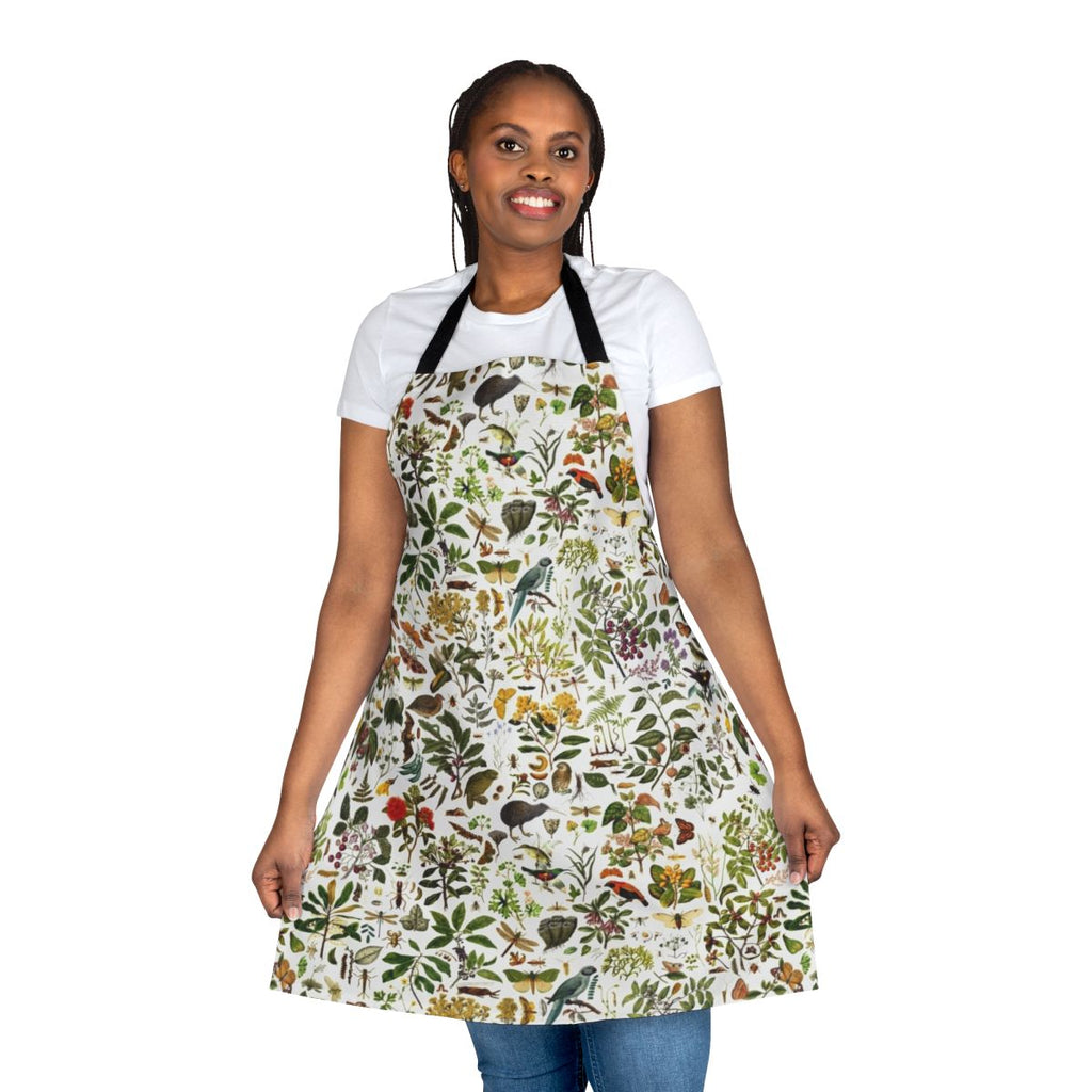 A colorful apron featuring a detailed, seamless pattern of native New Zealand flora and fauna, including butterflies, birds, and botanical elements.
