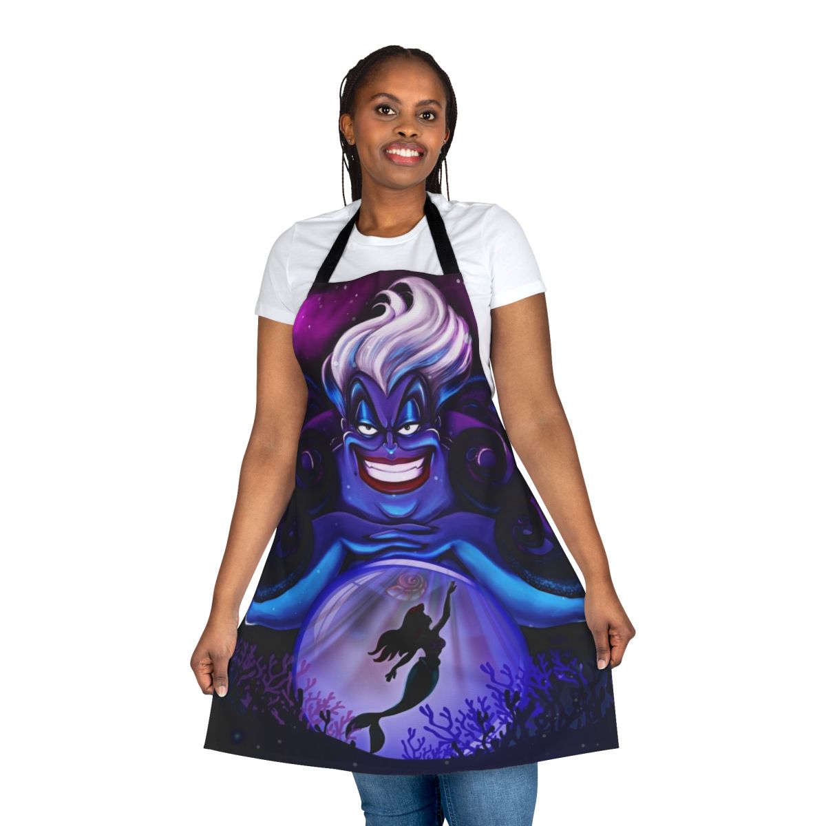 An apron featuring Ursula, the sea witch from Disney's The Little Mermaid, with her iconic crystal ball and ocean-themed design.