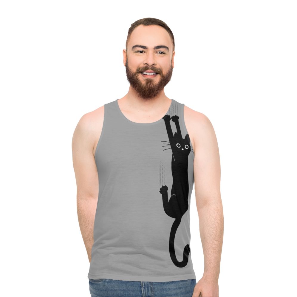 Black cat hanging on to tank top
