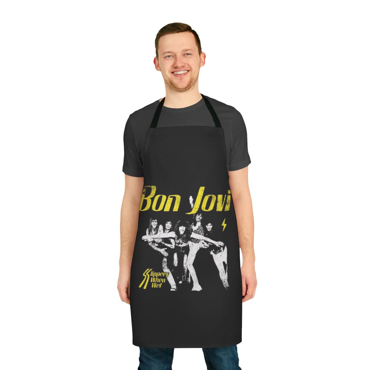 A black cooking apron featuring a heart dagger design, inspired by the Bon Jovi album "Slippery When Wet"