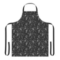 A denim apron featuring a dark, gothic skull pattern design.