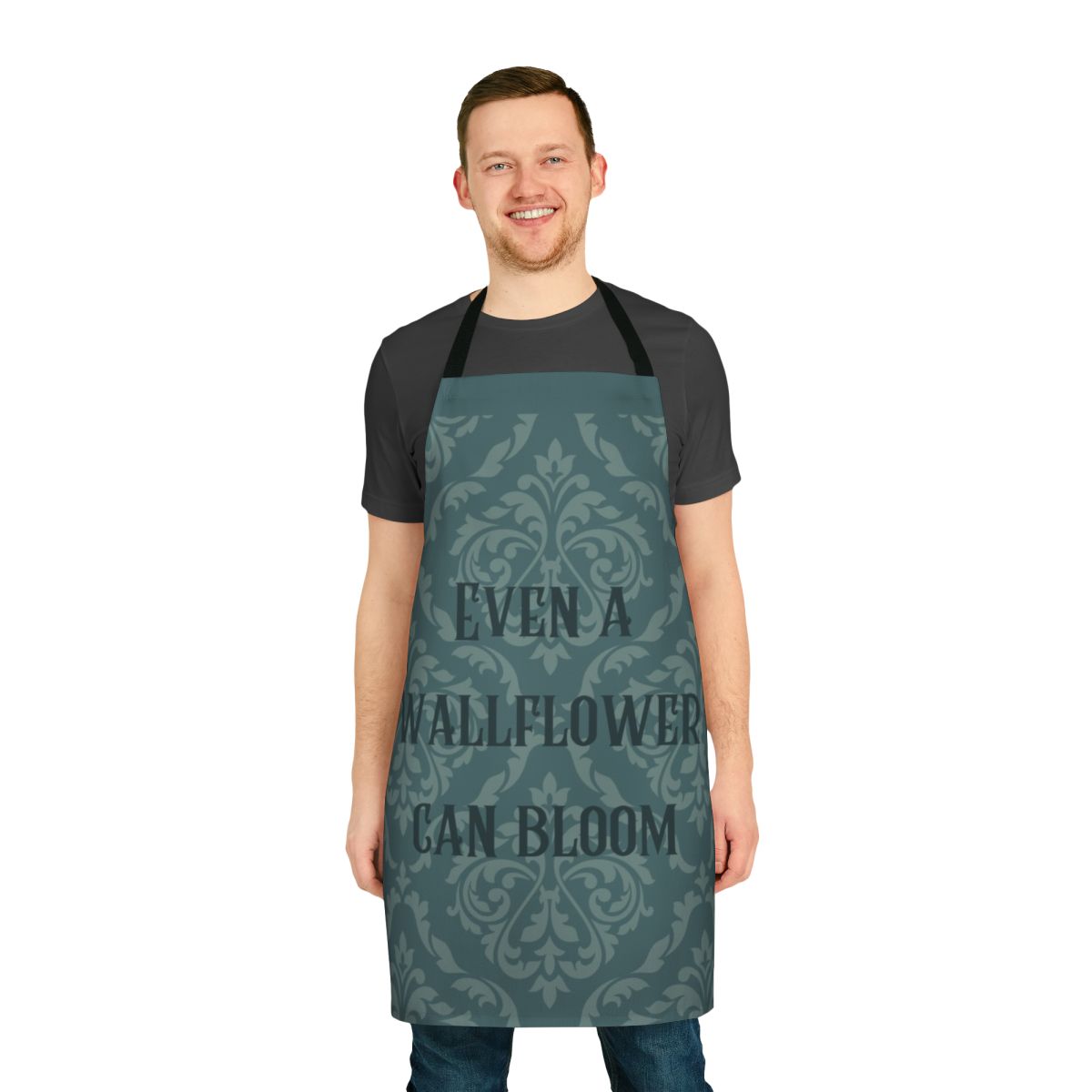 Vintage-style floral apron with text "Even A Wallflower Can Bloom"