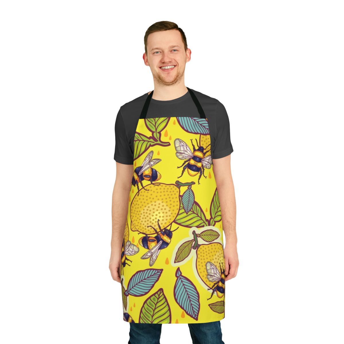 A vibrant yellow apron featuring a lemon and bee garden design