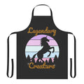 A white unicorn with a rainbow horn on a green foliage background, printed on a high-quality apron.