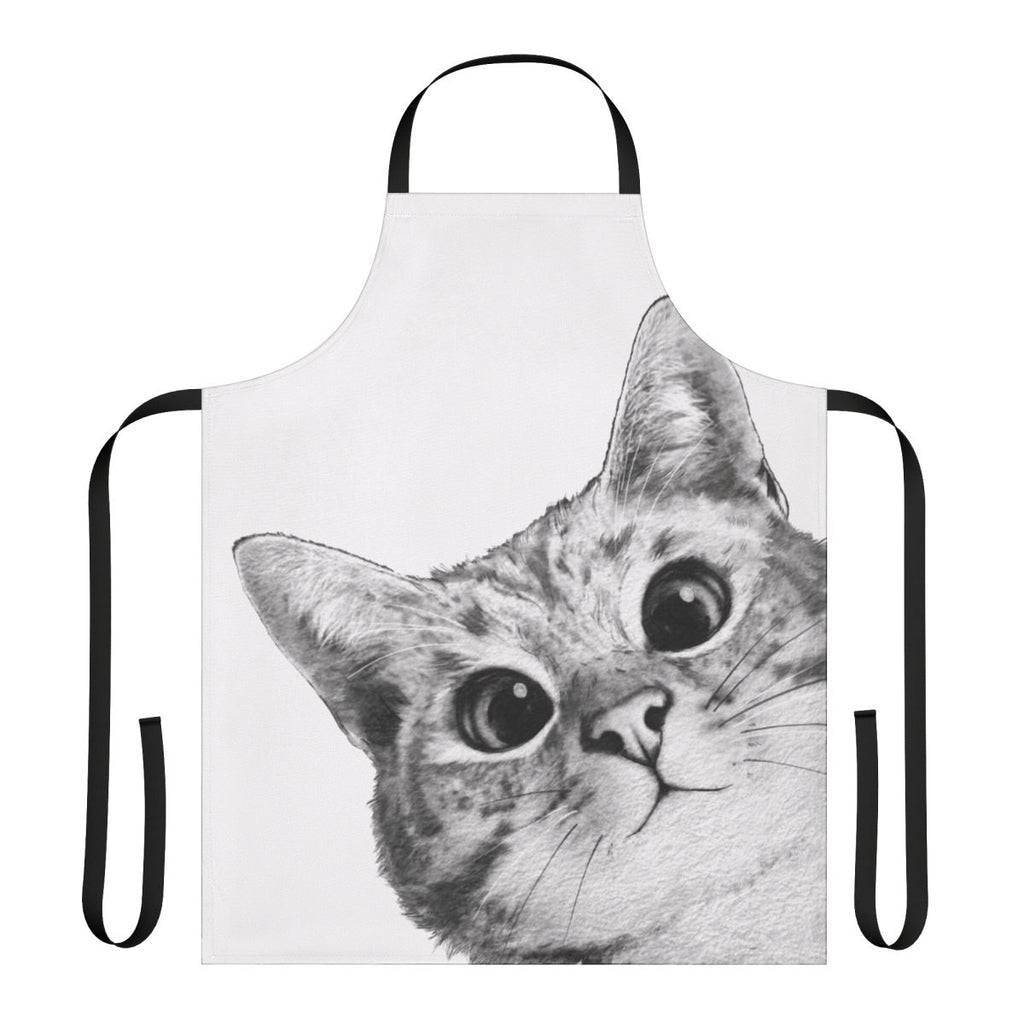 A black and white cat peeking out from behind a funny cat-themed kitchen apron