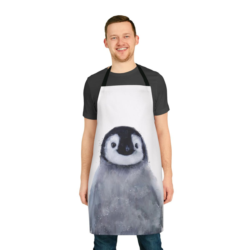 Cute penguin wearing an apron, standing in a snowy arctic landscape