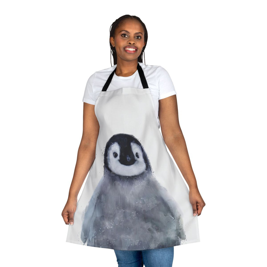 Cute penguin wearing an apron, standing in a snowy arctic landscape