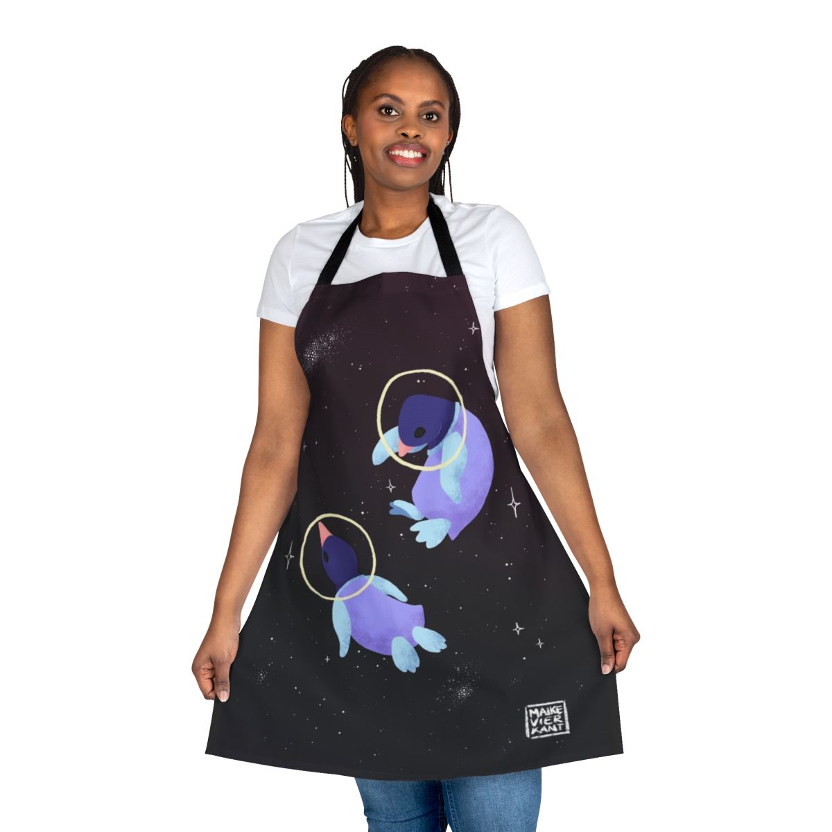 Whimsical apron featuring a cute penguin in an astronaut suit against a starry galaxy background