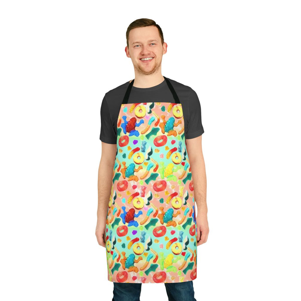 Whimsical apron featuring a vibrant pattern of gummy candies, sharks, and other sweets