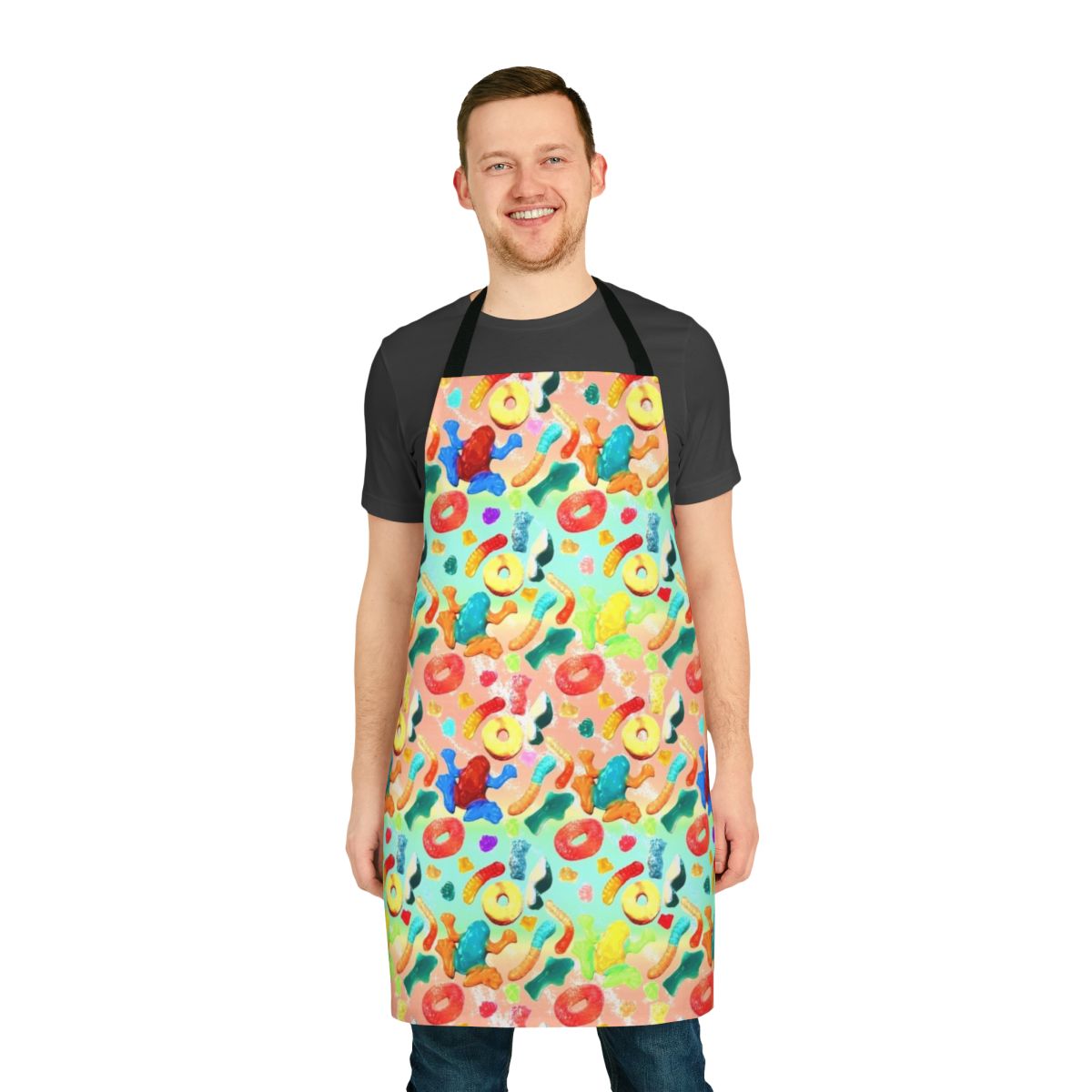 Whimsical apron featuring a vibrant pattern of gummy candies, sharks, and other sweets
