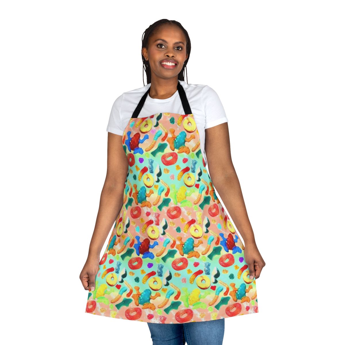 Whimsical apron featuring a vibrant pattern of gummy candies, sharks, and other sweets