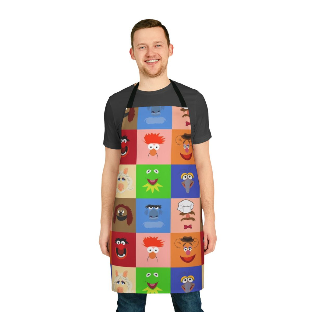 A vibrant apron featuring various Muppet characters like Kermit the Frog, Miss Piggy, and Gonzo.