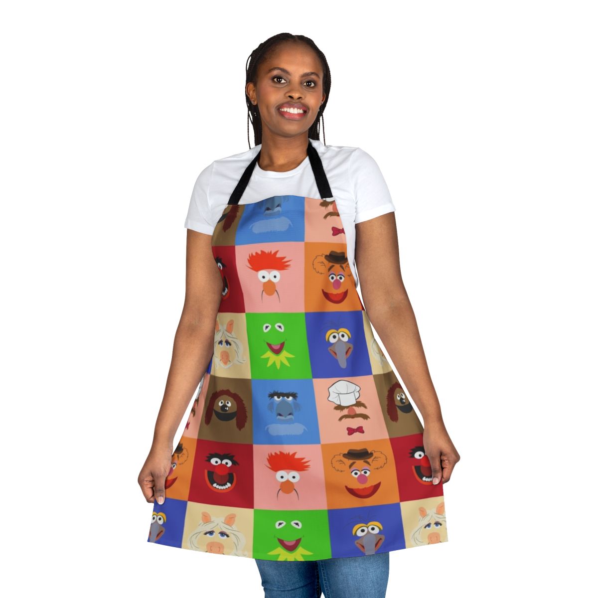 A vibrant apron featuring various Muppet characters like Kermit the Frog, Miss Piggy, and Gonzo.