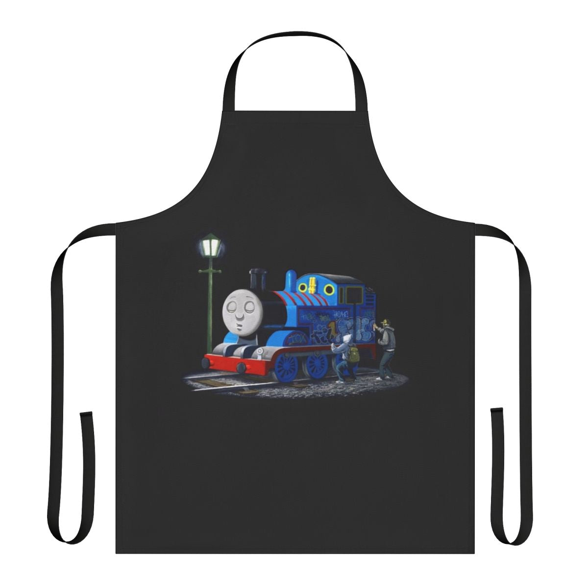 A black and white apron featuring a Banksy-style stencil graffiti design of Thomas the Tank Engine, a popular cartoon character.