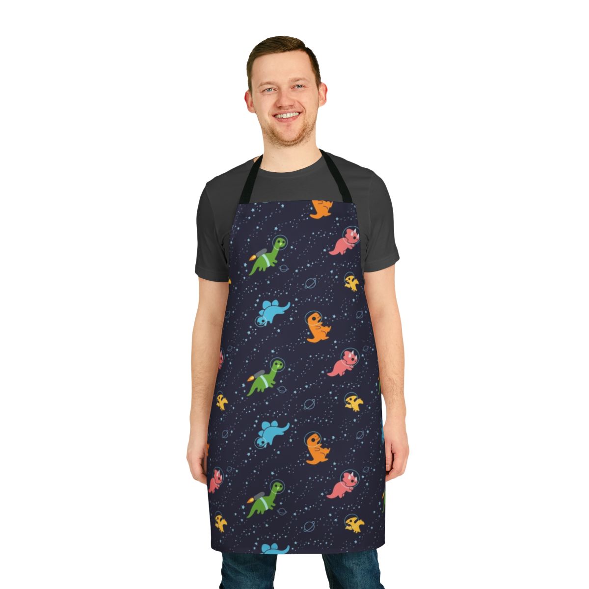 Whimsical apron featuring a pattern of dinosaurs floating in space against a starry galaxy backdrop