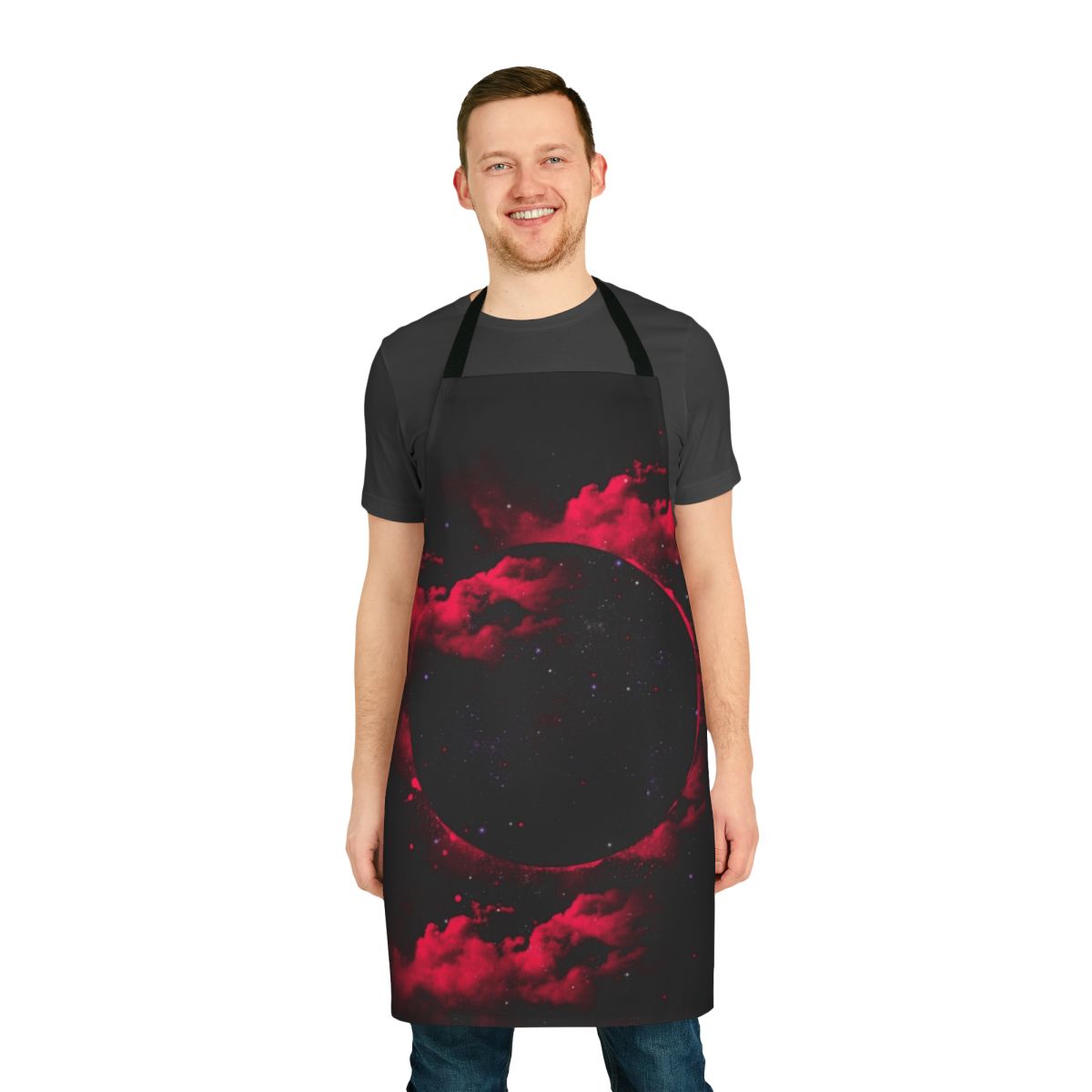 A stylish black and pink apron with a cosmic, space-themed design featuring stars, planets, and a black hole.