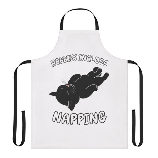 Apron featuring a black cat napping and the text "Hobbies Include Napping"