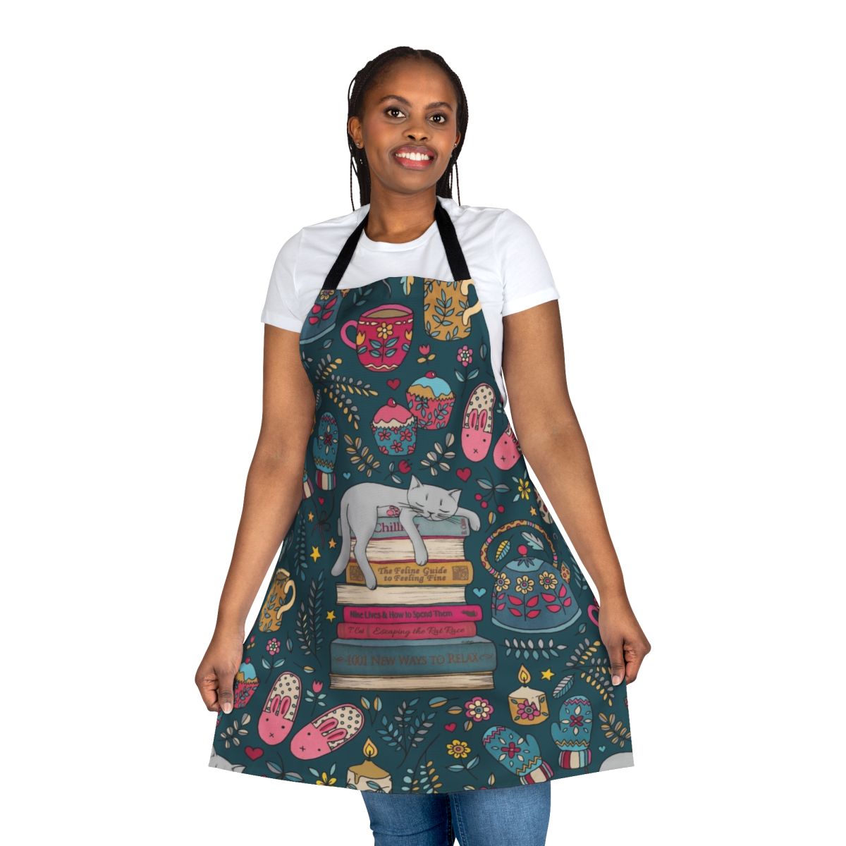 A dark green and pink apron with a cute cat sleeping on a book design, perfect for embracing the hygge lifestyle.