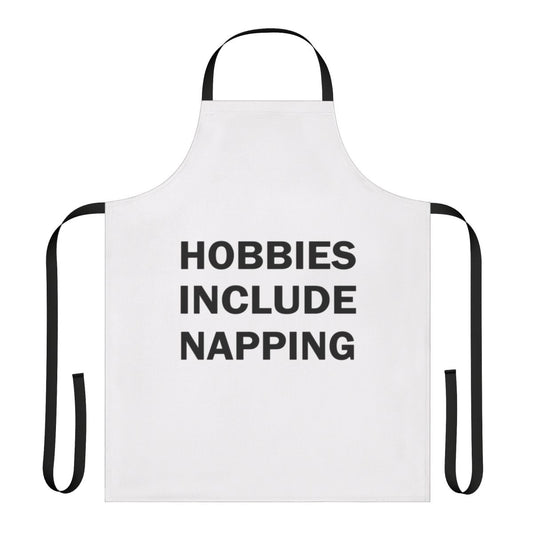 A white apron with a playful "Hobbies Include Napping" design, perfect for taking power naps or enjoying a relaxing rest.