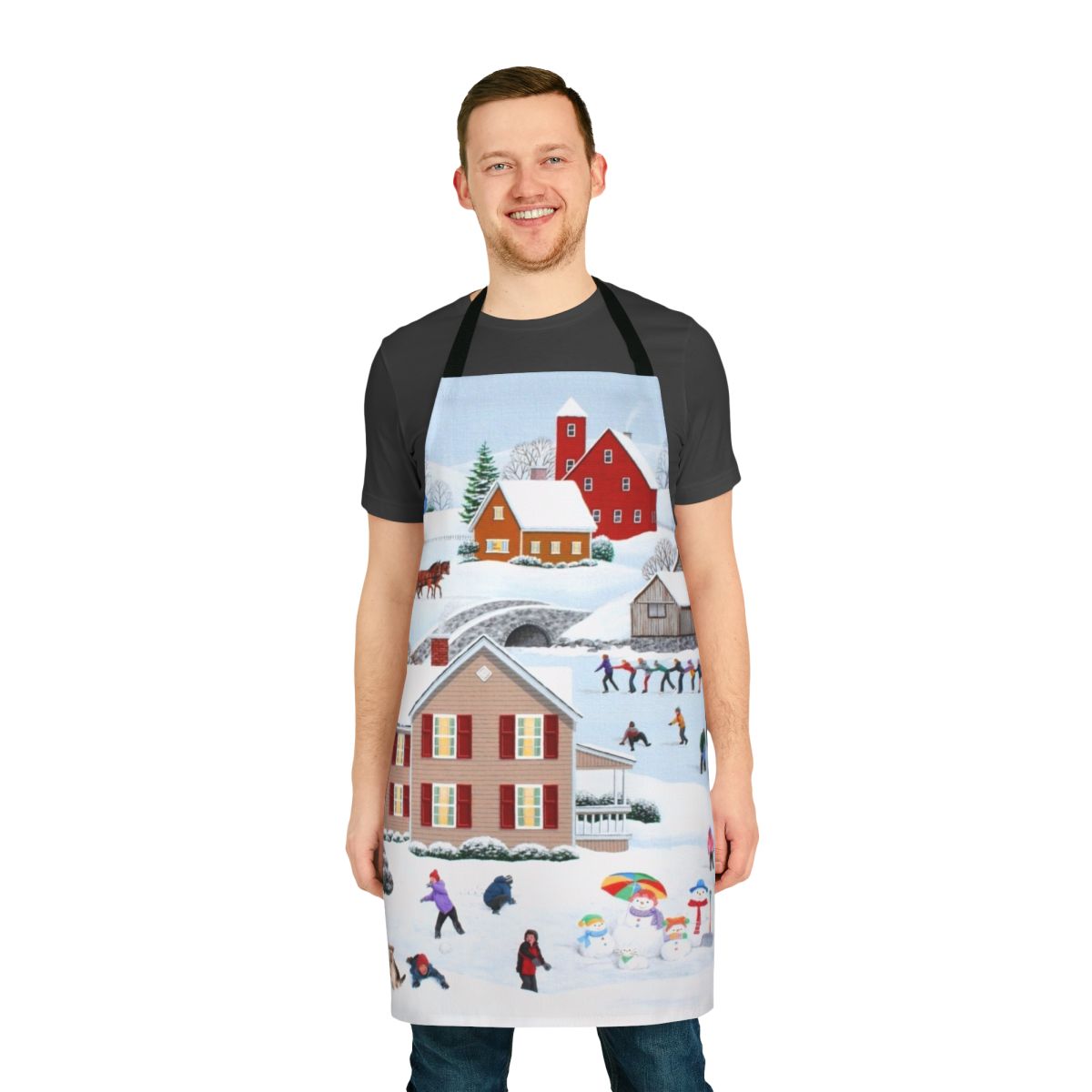 A winter themed apron featuring a snowy landscape with a snowman, tree, and ice skaters.