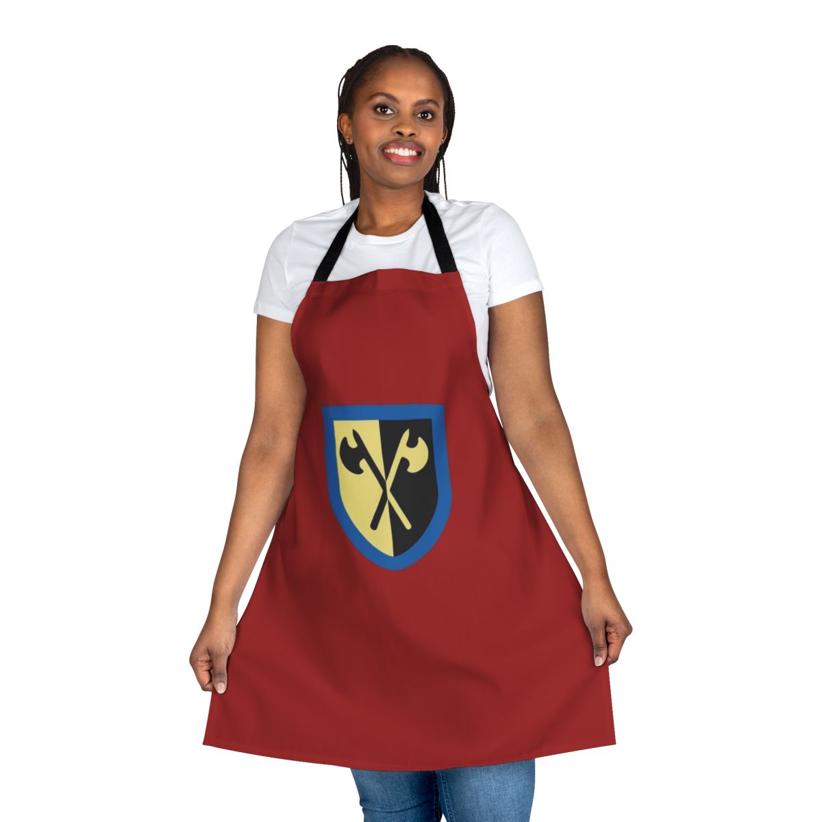 Image of a navy blue apron featuring a design inspired by Lego's Crusader knights, with crossed axes and a shield crest.