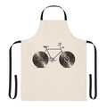 A colorful apron featuring musical notes, bikes, and vinyl records, perfect for kitchen or workshop use.