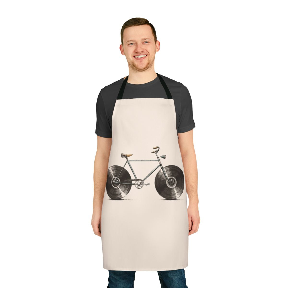A colorful apron featuring musical notes, bikes, and vinyl records, perfect for kitchen or workshop use.