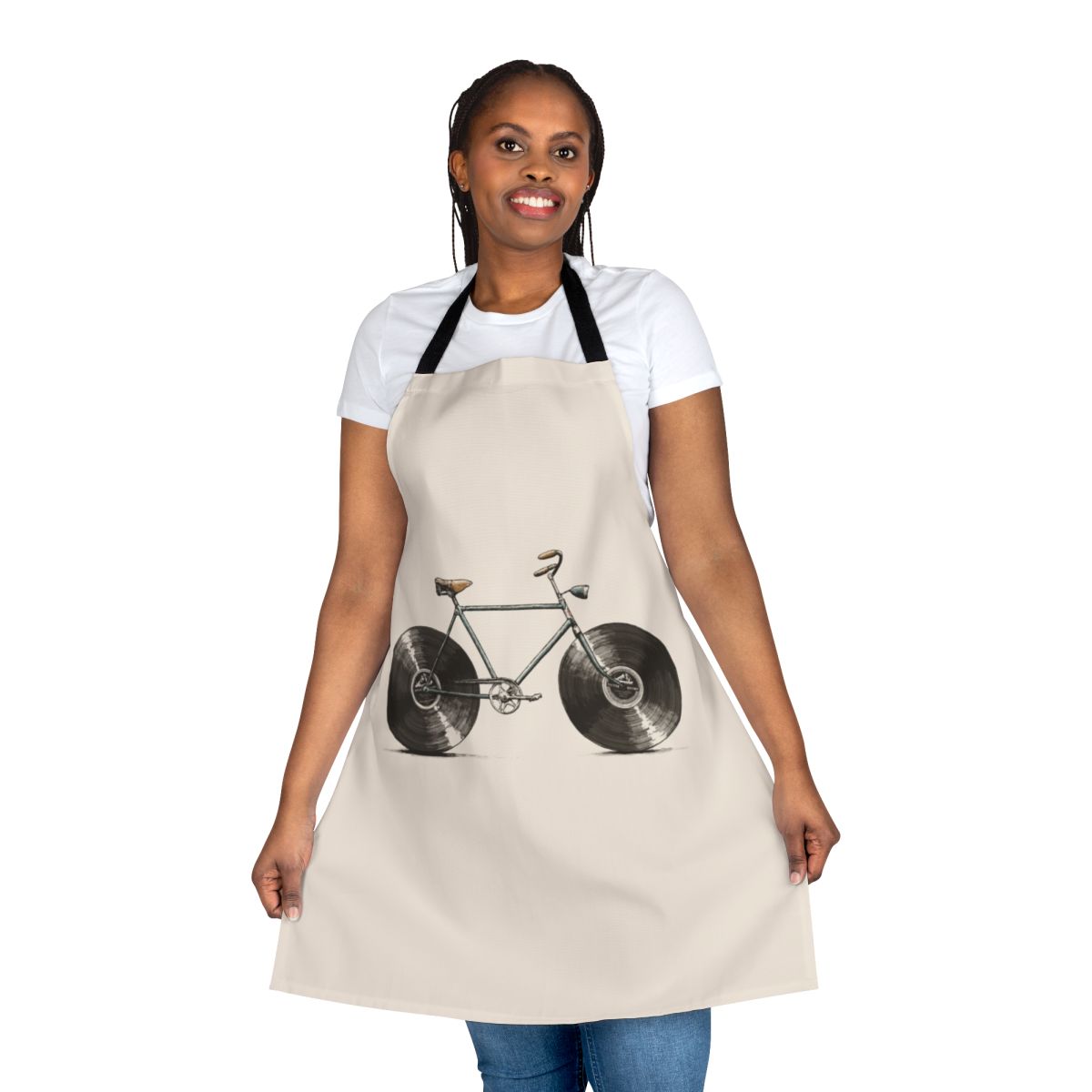 A colorful apron featuring musical notes, bikes, and vinyl records, perfect for kitchen or workshop use.