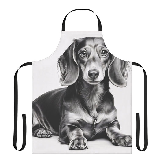 A black and white pencil sketch of a dachshund dog lying down, printed on a white kitchen apron.
