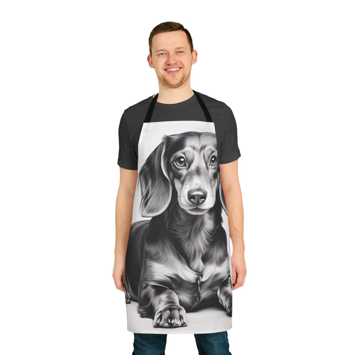 A black and white pencil sketch of a dachshund dog lying down, printed on a white kitchen apron.