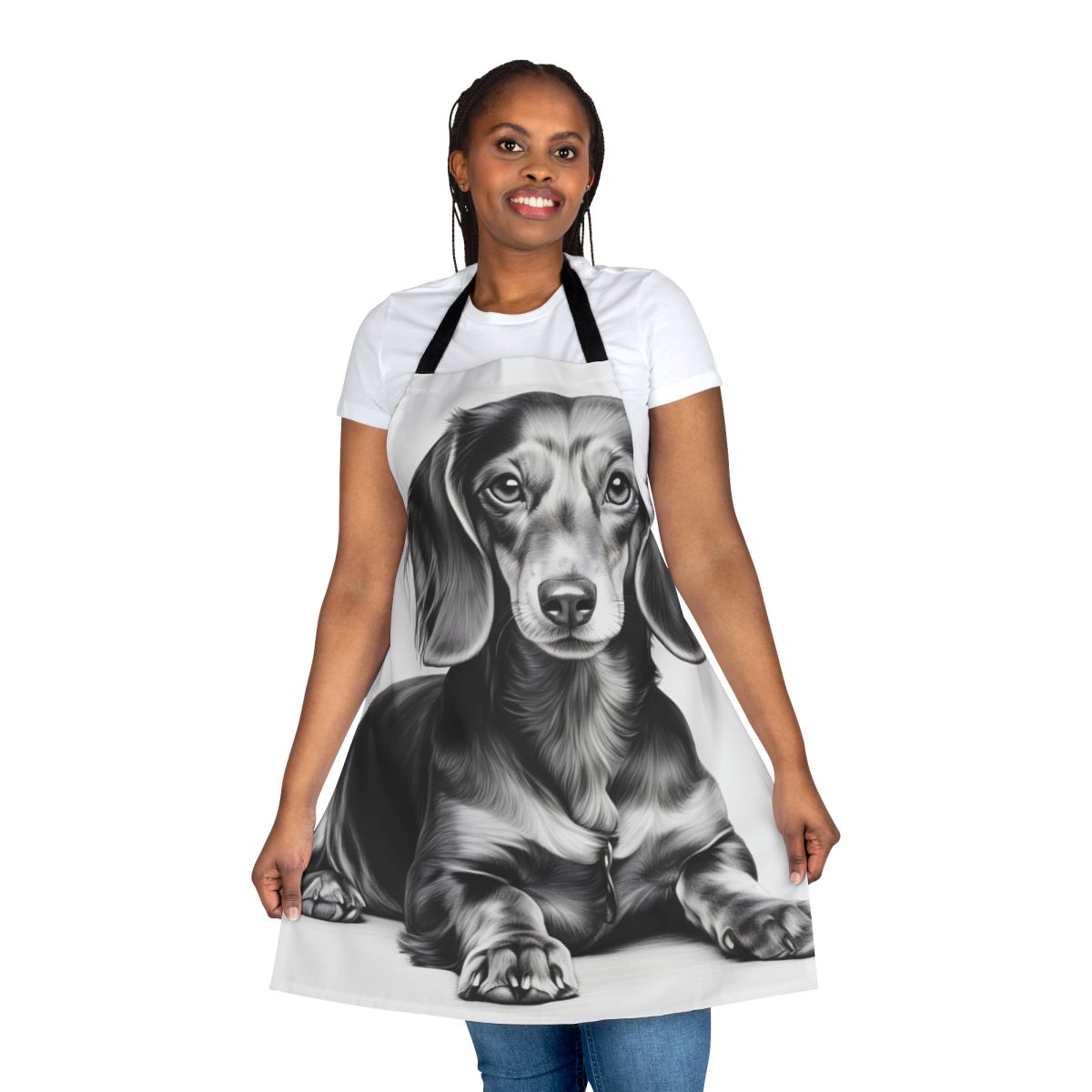 A black and white pencil sketch of a dachshund dog lying down, printed on a white kitchen apron.