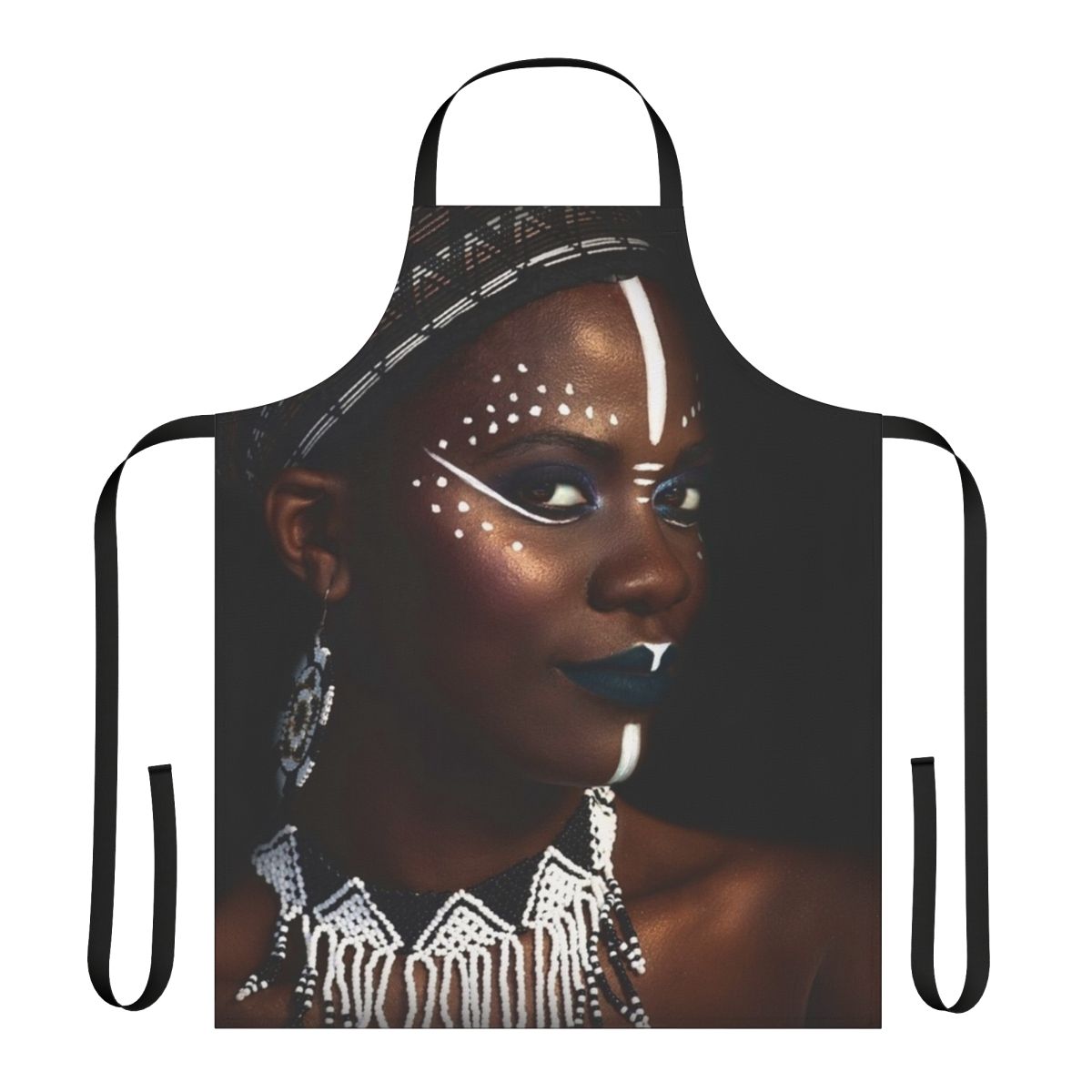 A decorative tribal-inspired apron featuring an abstract face design with gold dust and jewelry elements.