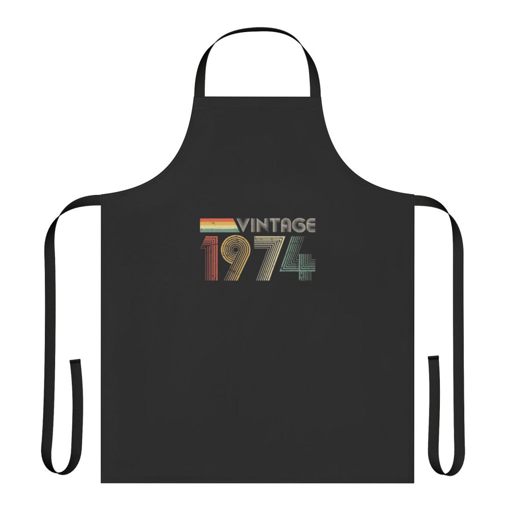A distressed, vintage-style apron with the year 1974 printed on it, perfect for a 50th birthday celebration.