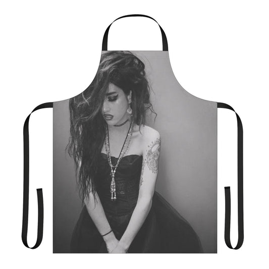 Black and white apron featuring the name "Adore Delano" and inspired by the drag performer